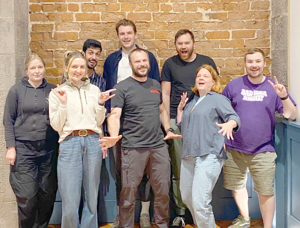 A group of Dundee Founders Collective founders posing in front of a brick wall